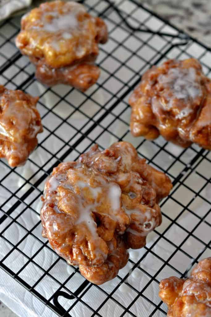 Apple Fritters are deep fried donuts filled with apples, cinnamon and drizzled with an easy three ingredient glaze.