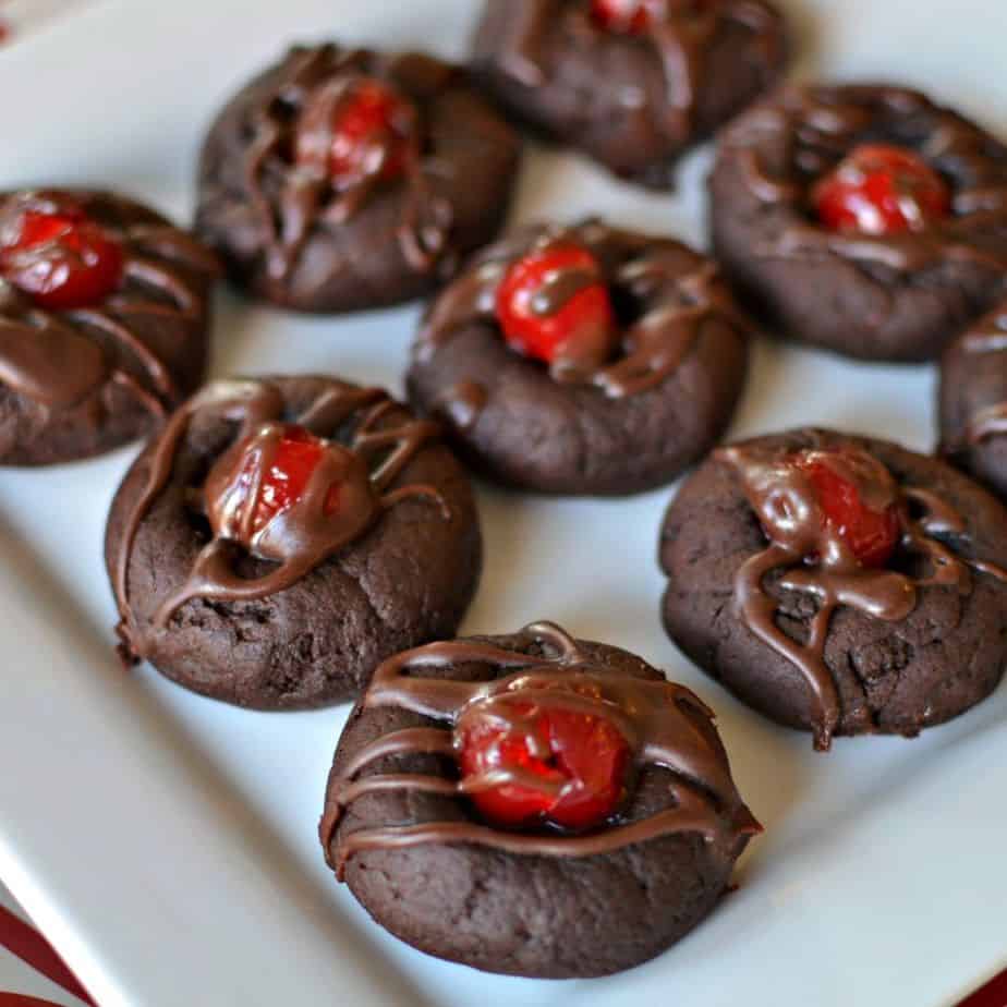 These Chocolate Cherry Cookies are soft fudge cookies with a sweet maraschino cherry right in the center and then drizzled with a chocolate fudge sauce.