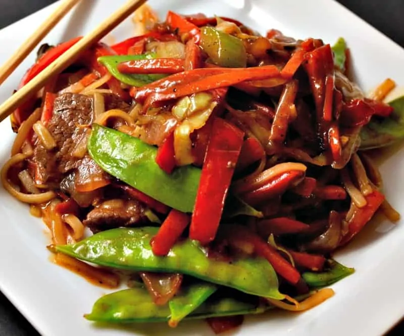 This Beef Lo Mein combines tender beef, onions, peppers, carrots, snow peas and rice noodles in a ginger soy sauce. 