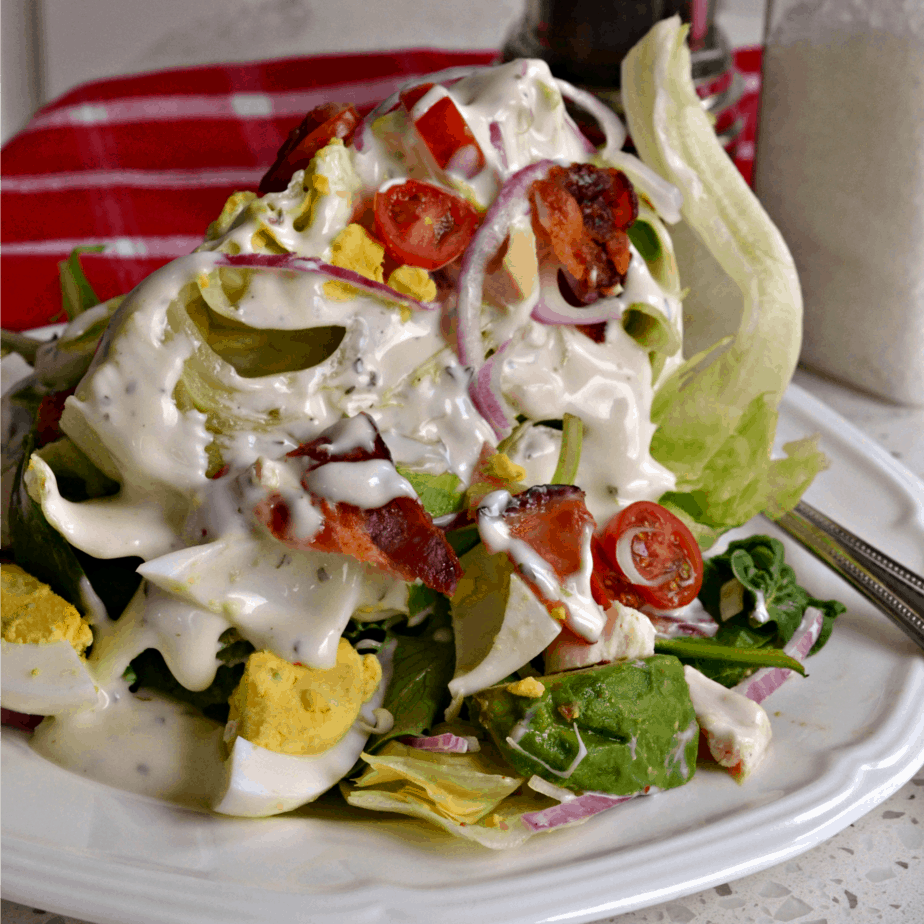 This easy Loaded Wedge Salad is sure to become one of your favorites. With the flavors of goodies like bacon, tomato, avocado, and chicken it is sure to please.   