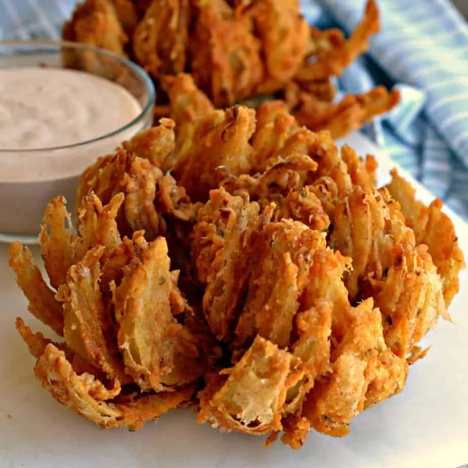 These easy Blooming Onions are double coated with a slightly spicy breading and deep fried to golden perfection.