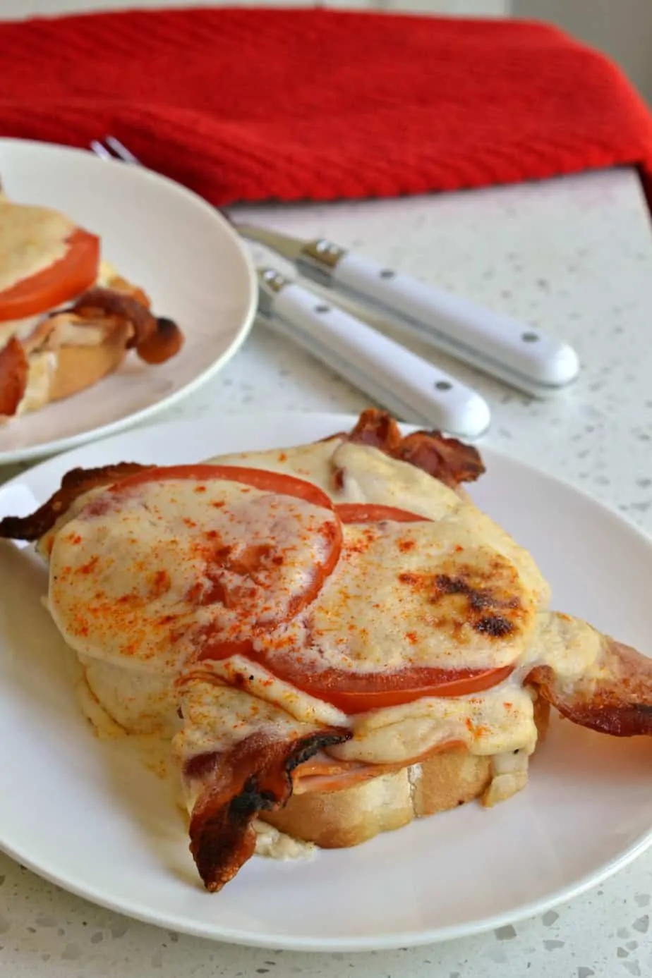 This delectable Hot Brown Sandwich is layered with roasted turkey, bacon, and creamy cheese sauce.