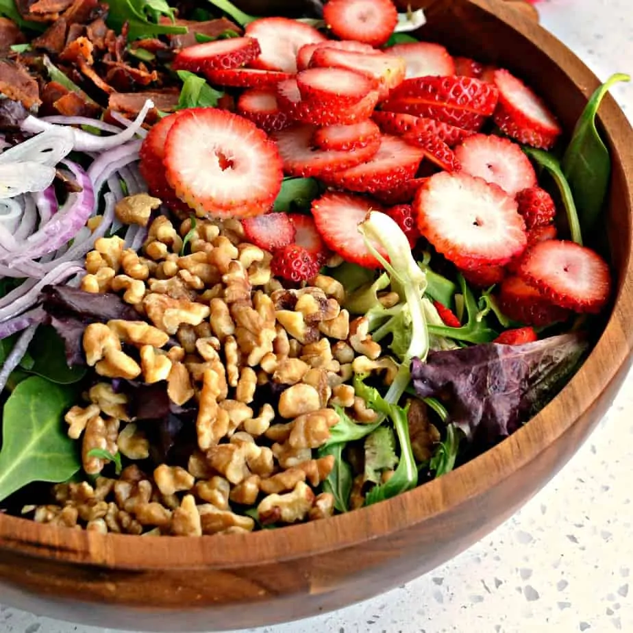 Sweet and crunchy Strawberry Spinach Salad with poppy seed dressing combines fresh strawberries, red onions, feta, crisp walnuts and smoked bacon. 