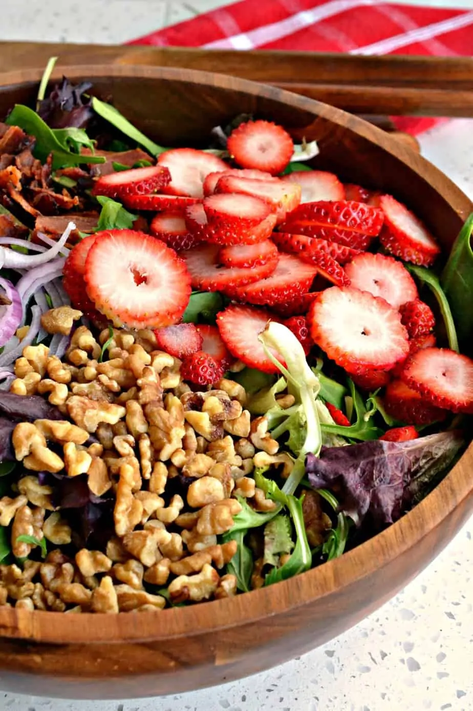 This Strawberry Spinach Salad with bacon and walnuts is always a hit for spring and summer gatherings. 