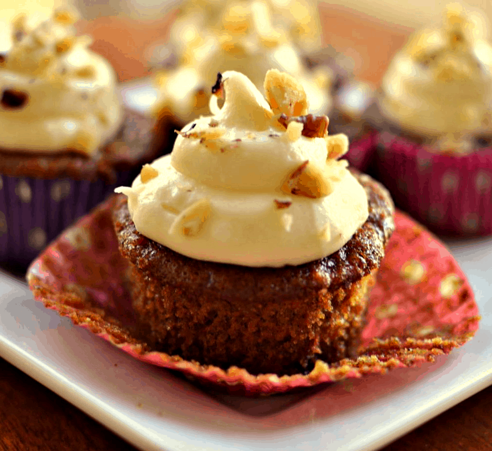These moist Carrot Cake Cupcakes with crushed pineapple and walnuts are topped with a white chocolate cream cheese frosting.