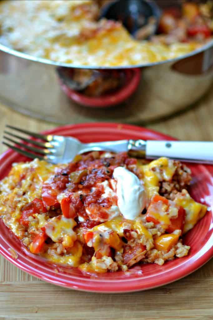 This protein packed Chicken Fajita Casserole comes together quickly and easily.  It combines delicious seasoned chicken with sweet veggies, brown rice and plenty of melted cheddar cheese.