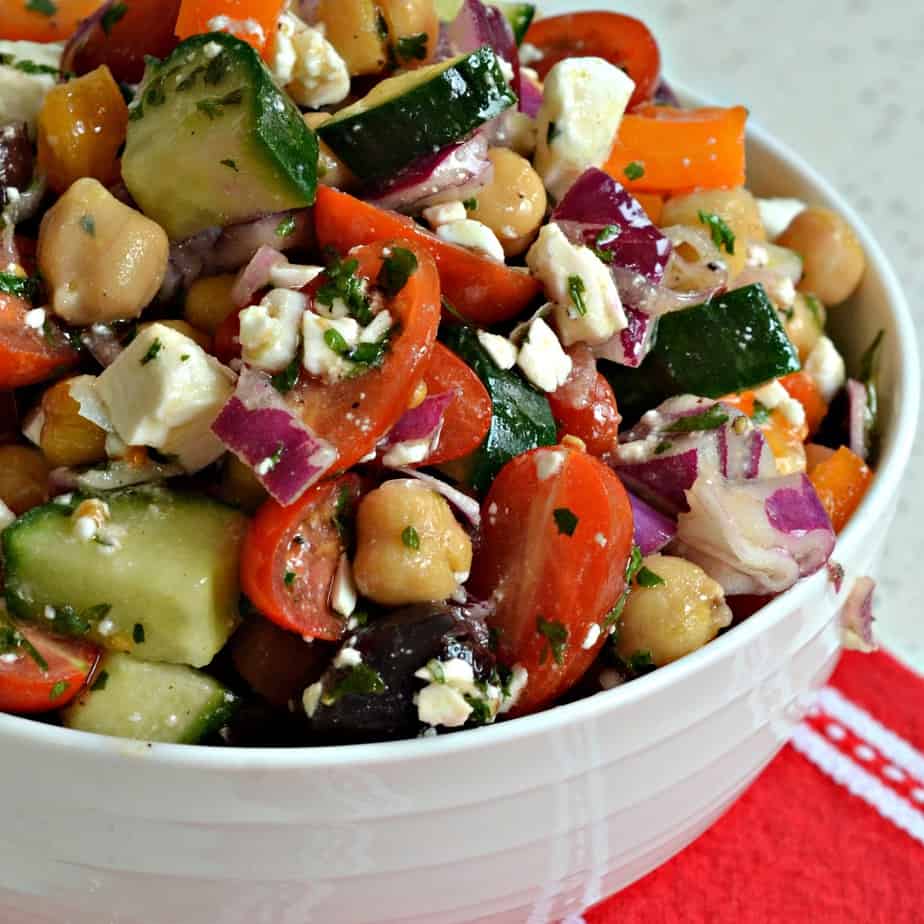 A delicious Mediterranean Salad made with chickpeas, cucumbers, red onions, bell peppers, tomatoes and feta cheese. 