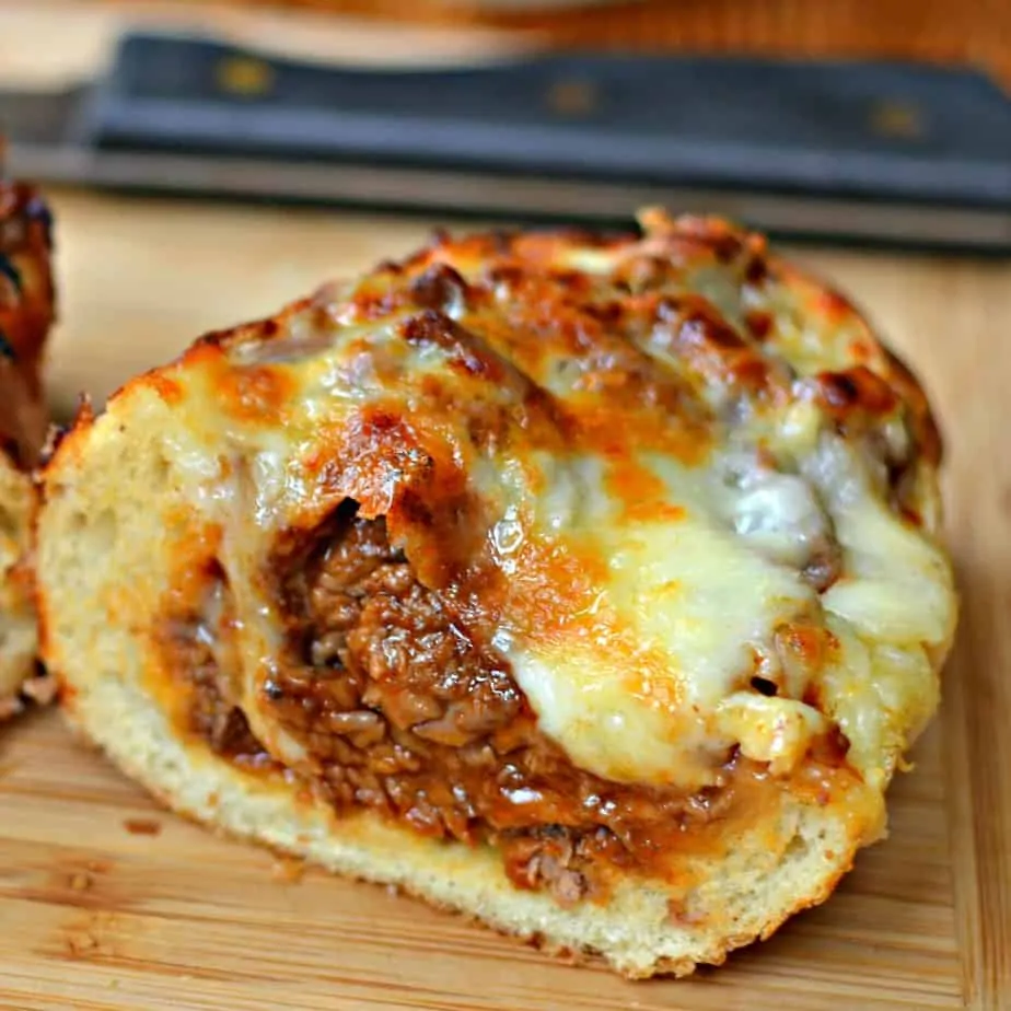 Delicious tender bites of steak in a slightly spicy tangy sauce are stuffed in french bread and topped with melted cheese. 
