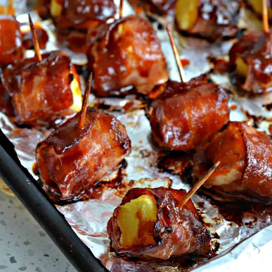 Bacon Wrapped Pineapple is basted with a semi-sweet, slightly spicy oriental sauce and baked to crispy golden perfection. 