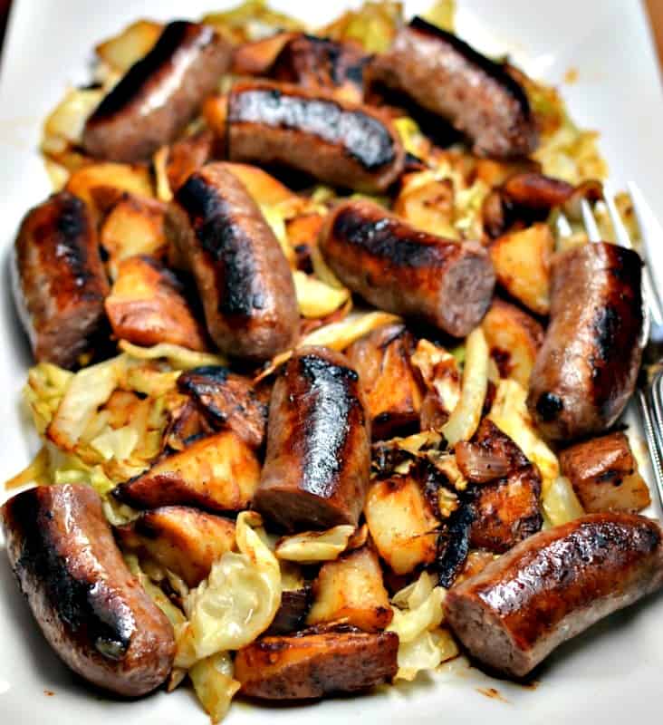 This family-friendly easy skillet recipe comes together in less than 30 minutes combining bratwurst, onions, potatoes, and cabbage into a super tasty tangy mustard vinegar sauce.