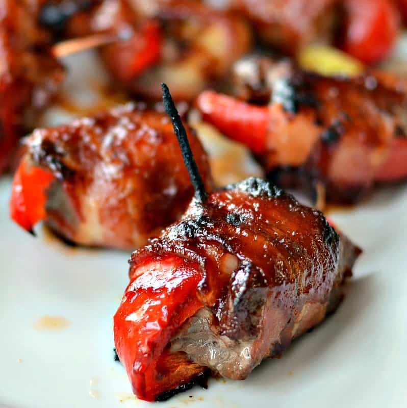 A rumaki appetizer recipe with beef tenderloin, bell pepper, water chestnuts and scallions all wrapped in bacon. 