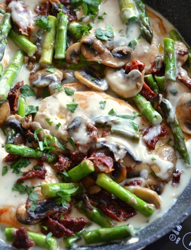 Creamy mushroom chicken topped with sun dried tomatoes and asparagus