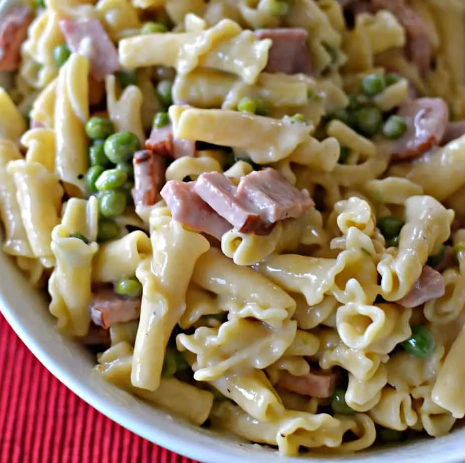This Ham and Pea Campanelle combines smokey ham, sweet peas and pasta in a lightly seasoned super creamy cheese sauce. 