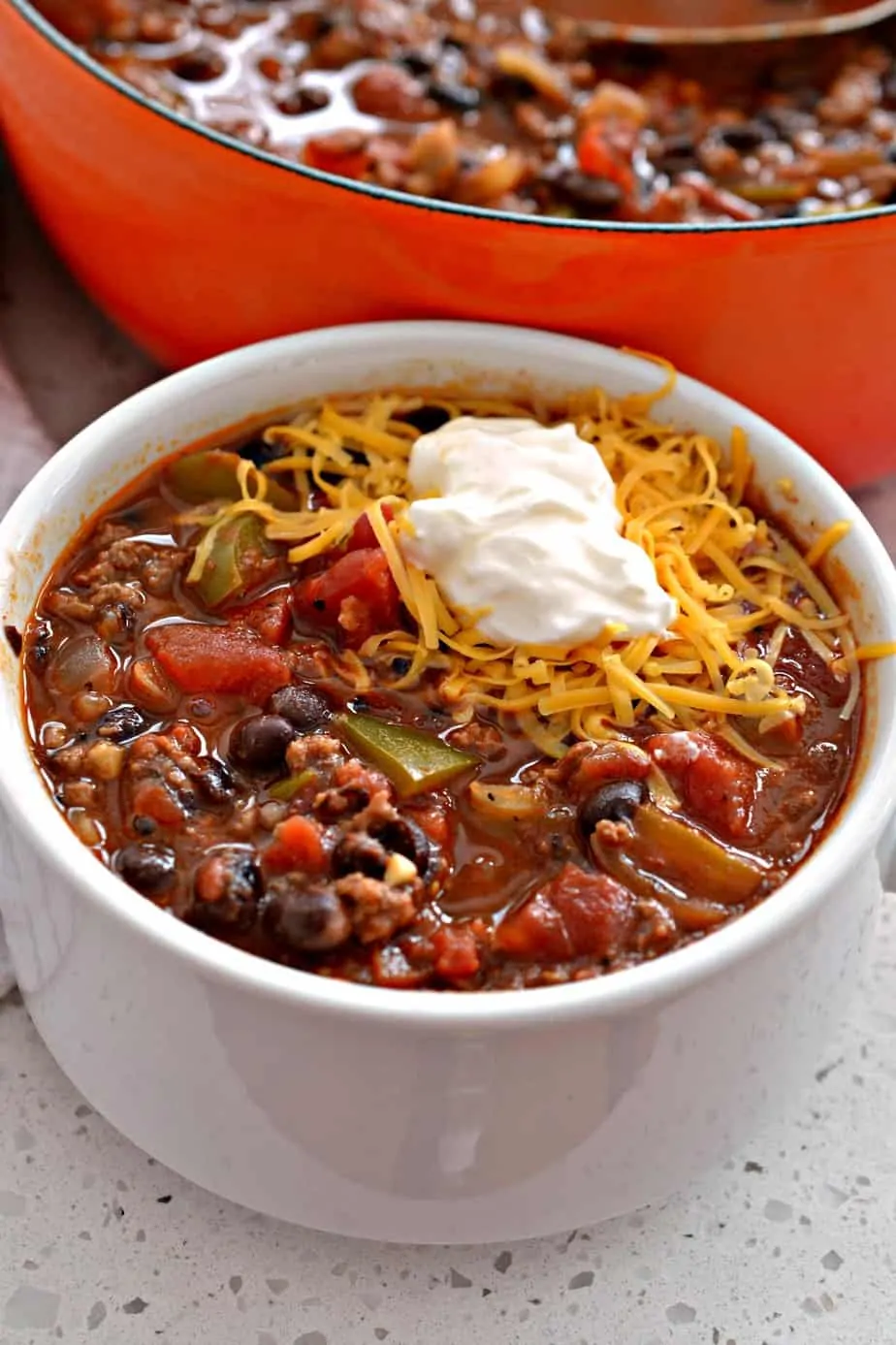 This thick and hearty beef and bean chili recipe is perfect for the cold winter months. This simple recipe is freezer-friendly, perfect for a weeknight family dinner, and packed with veggies.