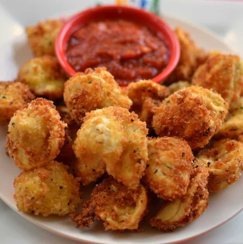 These crispy fried tortellini are sprinkled with Parmesan cheese and served with a hearty marinara