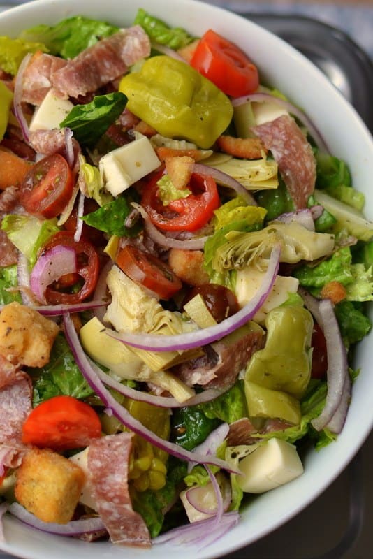 This Italian chopped salad is packed with delicious veggies, salami, and crispy croutons and dressed with a fresh homemade Italian dressing