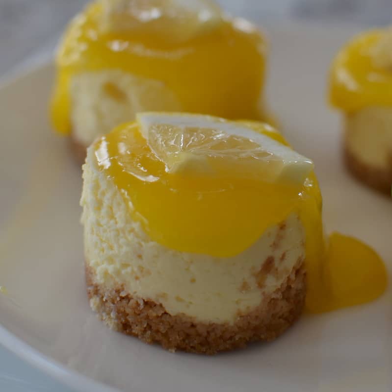 A microwavable lemon curd tops these sweet and light cheesecake bites