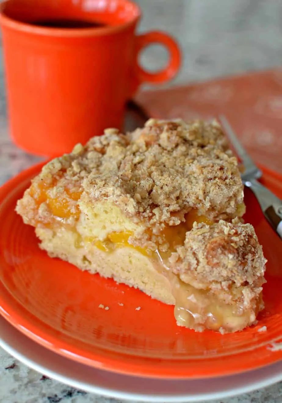 This Peach Coffee Cake has a sour cream cake base, peach center and crunchy crumb oatmeal topping. 