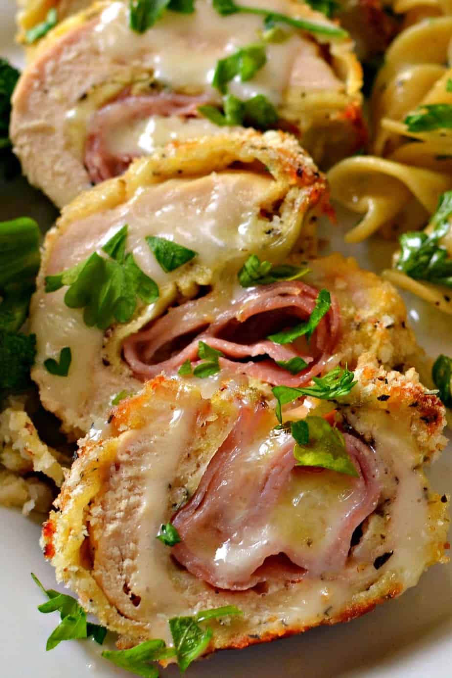 Chicken Cordon Bleu is crispy chicken breasts stuffed with ham and Swiss and topped with a creamy mustard cheese sauce. 