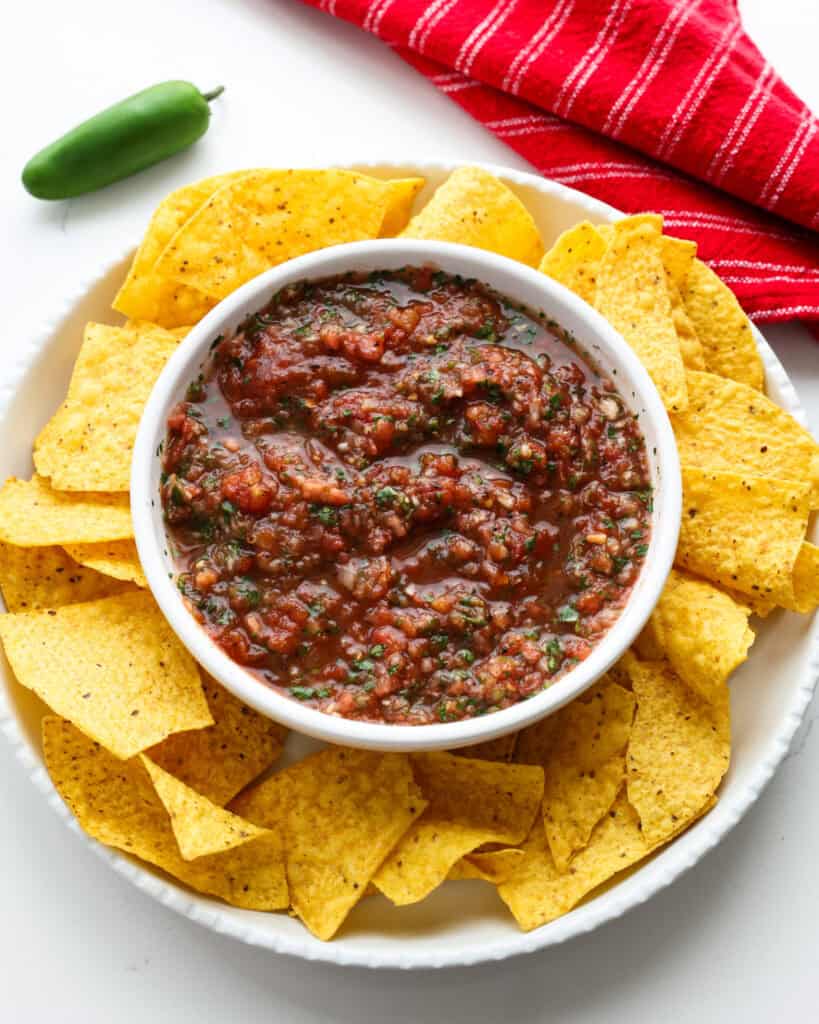Fresh Homemade Salsa Recipe An overhead view of a bowl full of homemade salsa surrounded by chips.