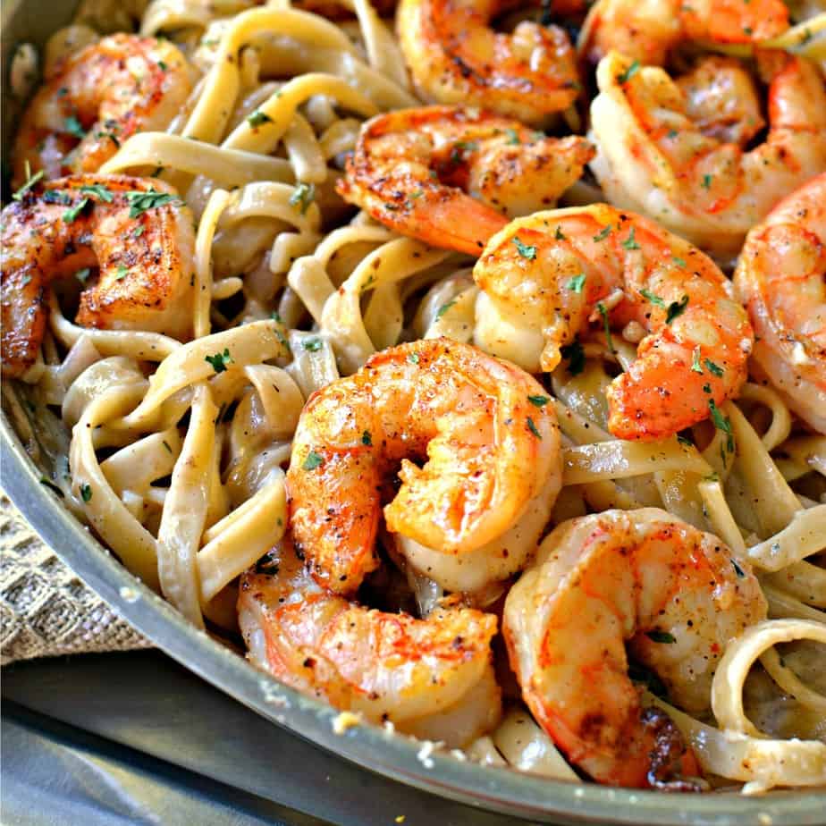 This easy family friendly fettuccine pasta combines  pan seared garlic shrimp with a creamy Cajun seasoned pasta sauce.