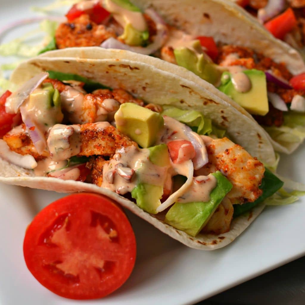 Tasty Chicken Tacos are topped with a delicious ranch dressing and fresh avocado sliders