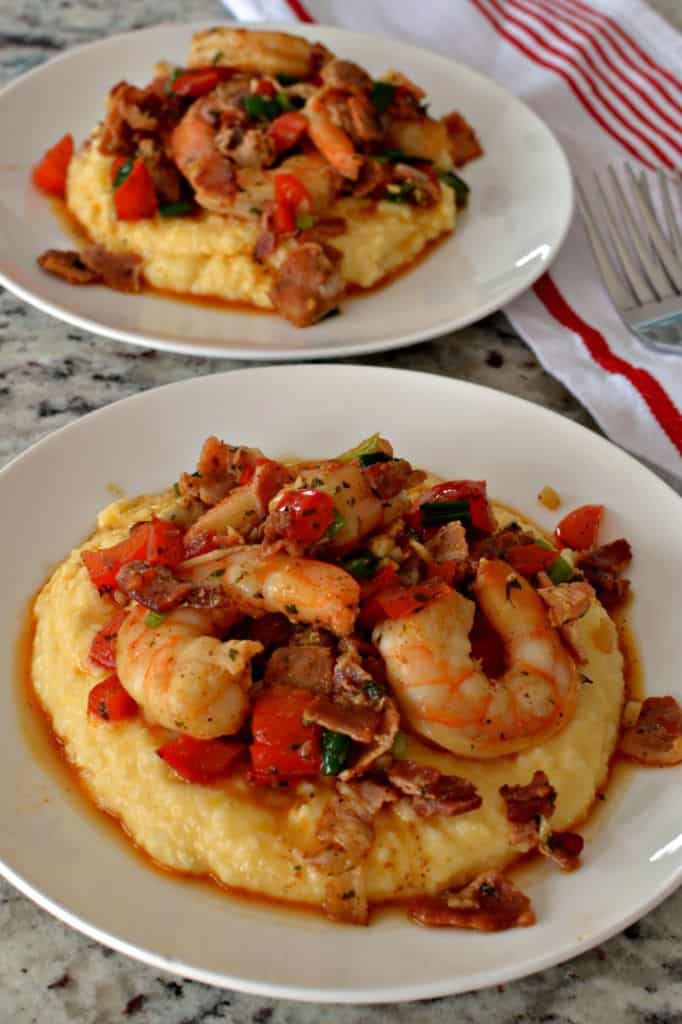 Shrimp cooked with creole seasoning, red pepper, green onions, crisp bacon and garlic over a bed of creamy cheddar grits.