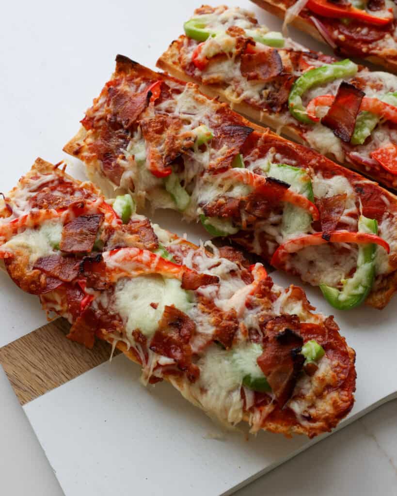 French bread pizza on a serving board. 