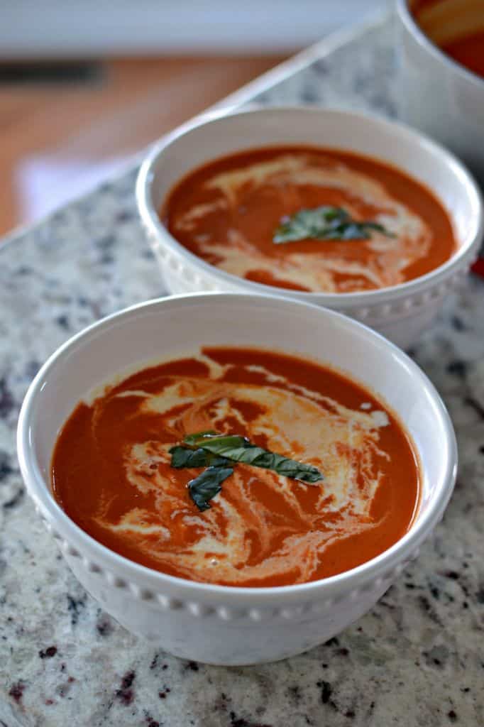 Serve this homemade tomato bisque with a drizzle of cream, topped with fresh basil