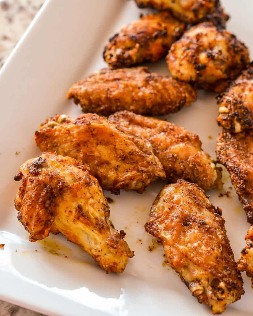 Air Fryer Chicken Wings a close up of Air Fryer Chicken Wings on a white platter.