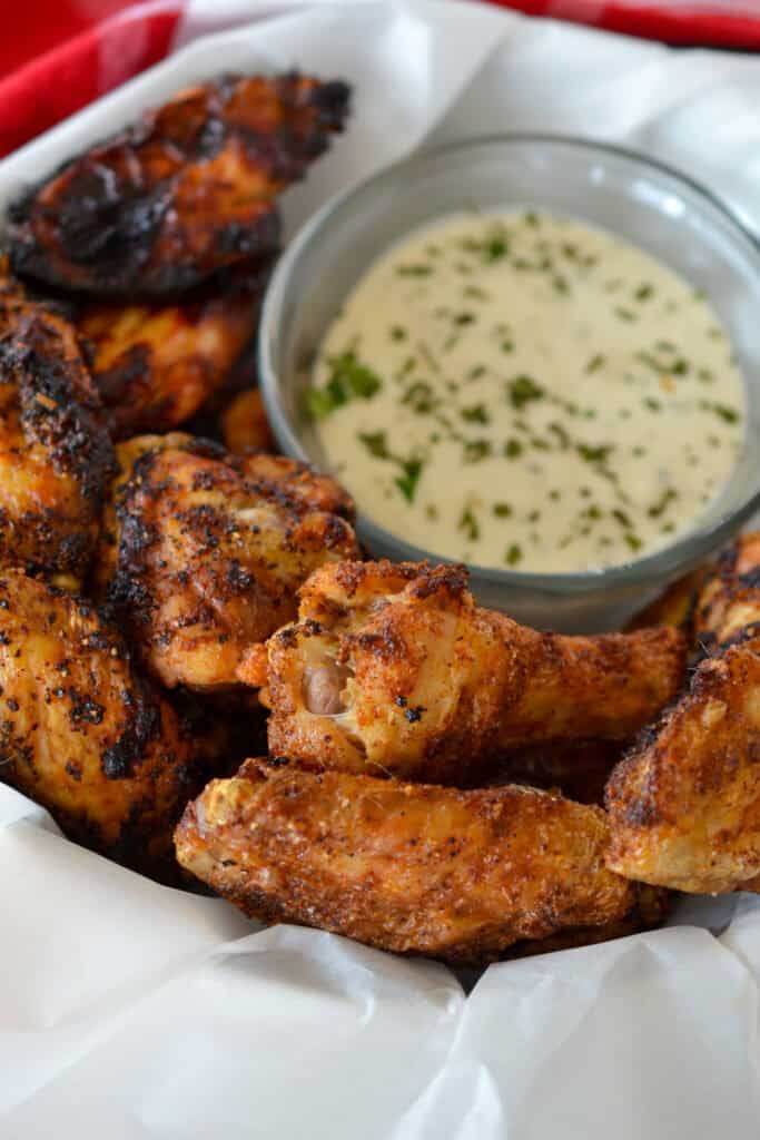 Air Fryer Chicken Wings Air Fryer Chicken Wings in a basket with ranch for dipping.