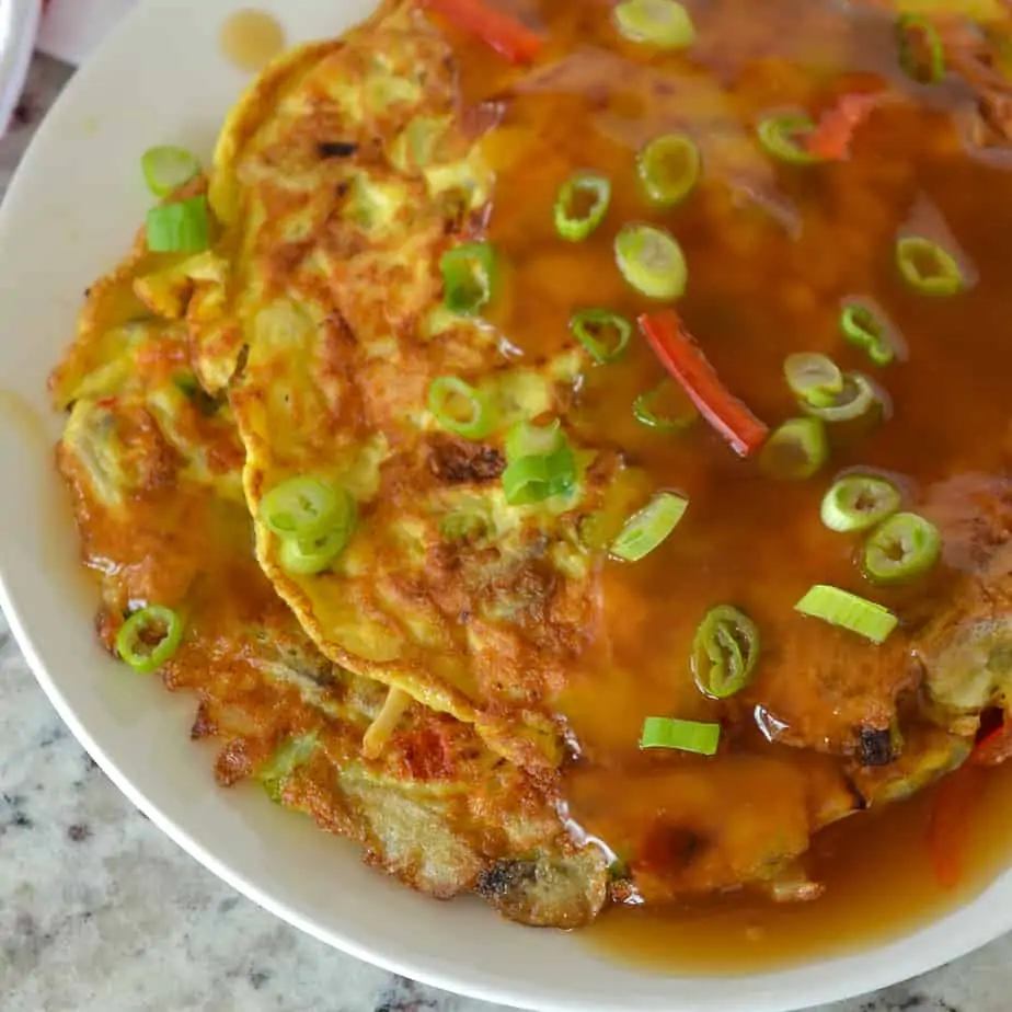 This delectable fluffy Chinese omelette is smothered in a scrumptious slightly salty sweet tangy gravy.