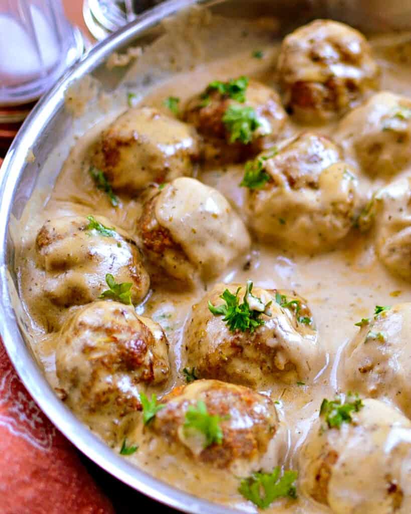 A skillet full of turkey meatballs in creamy gravy. 