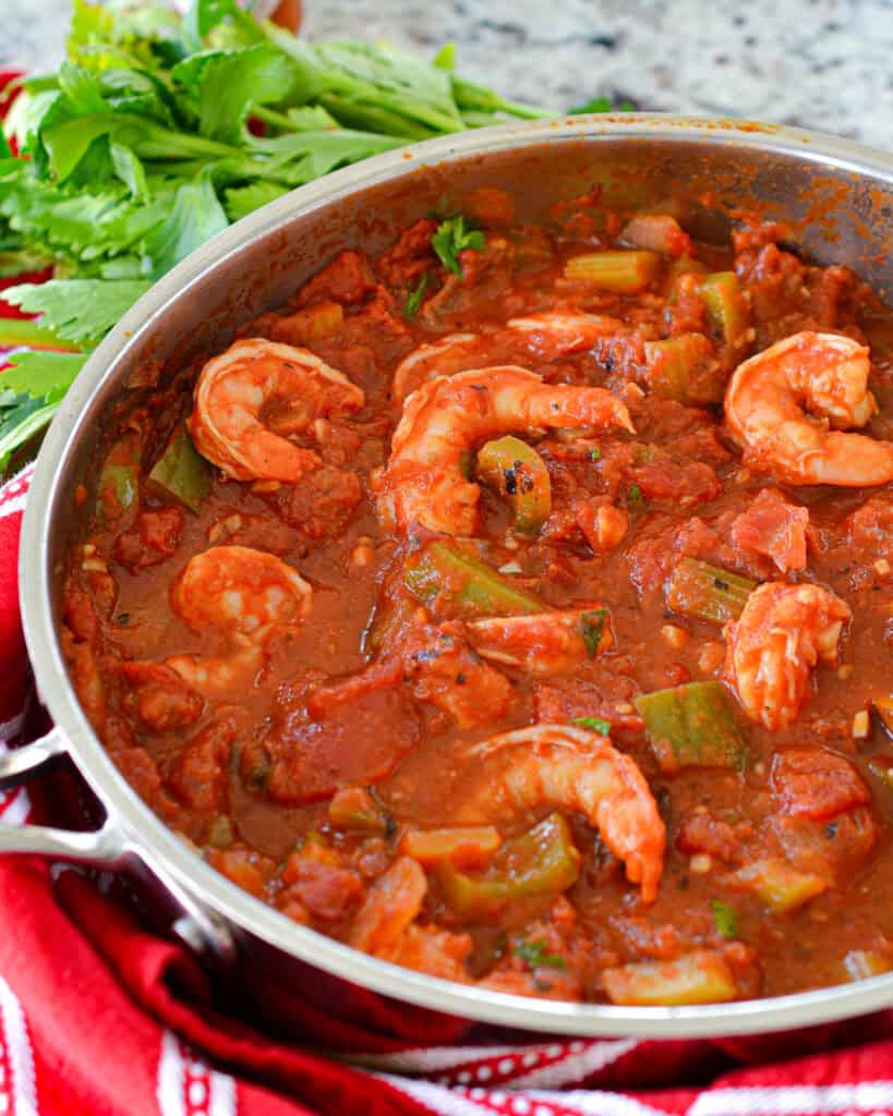 Stir in the Worcestershire sauce, stewed tomatoes, fire-roasted tomatoes, tomato sauce, and brown sugar. Cover the skillet and simmer for about twenty minutes to meld all the flavors together. Add the shrimp and simmer for two minutes.