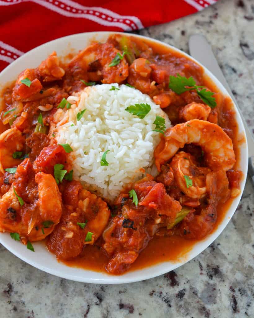 Shrimp Creole is plated with rice in the middle.