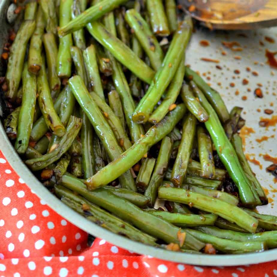 Make these delicious stir fried green beans, packed with flavorful garlic and ginger.