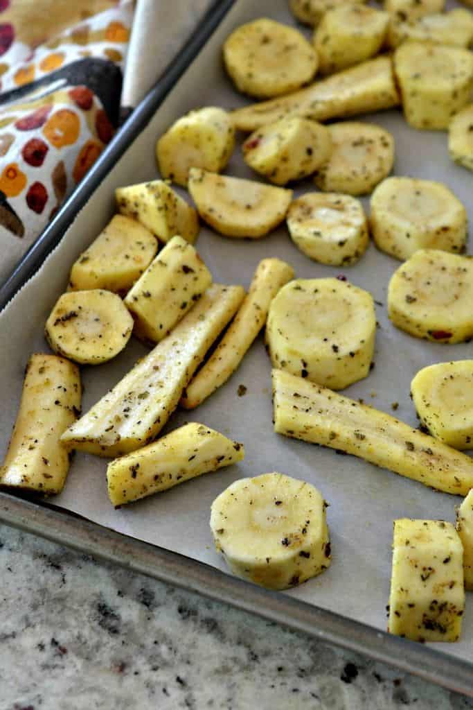 Herb-coated parsnips are ready to be roasted to a crisp golden brown