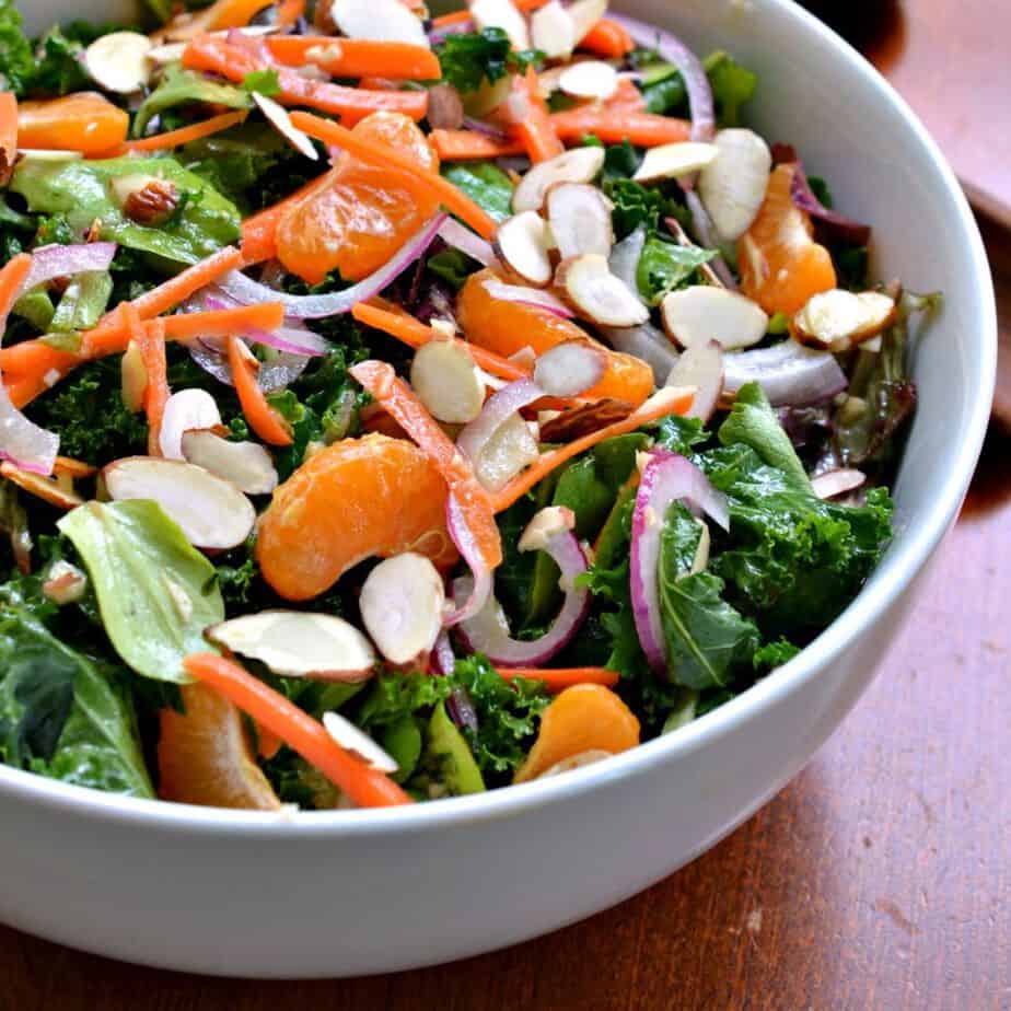 Topped with mandarin orange slices and crisp almonds, this kale salad with ginger Vinaigrette is a fresh Asian-inspired salad