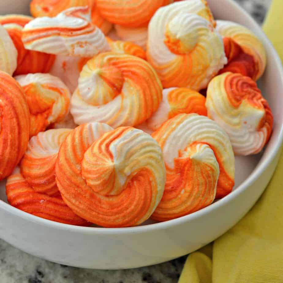 Meringue Cookies are easy to pipe and easy to color.  You can adjust the colors for different holidays or cover them with festive sprinkles.