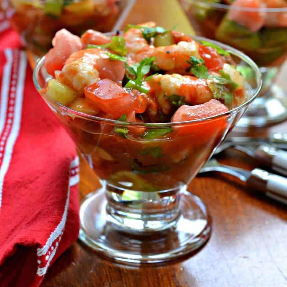 Mexican Shrimp Cocktail is shrimp, onions, celery, cucumbers, tomatoes, avocado, and jalapenos in a tomato dressing. 