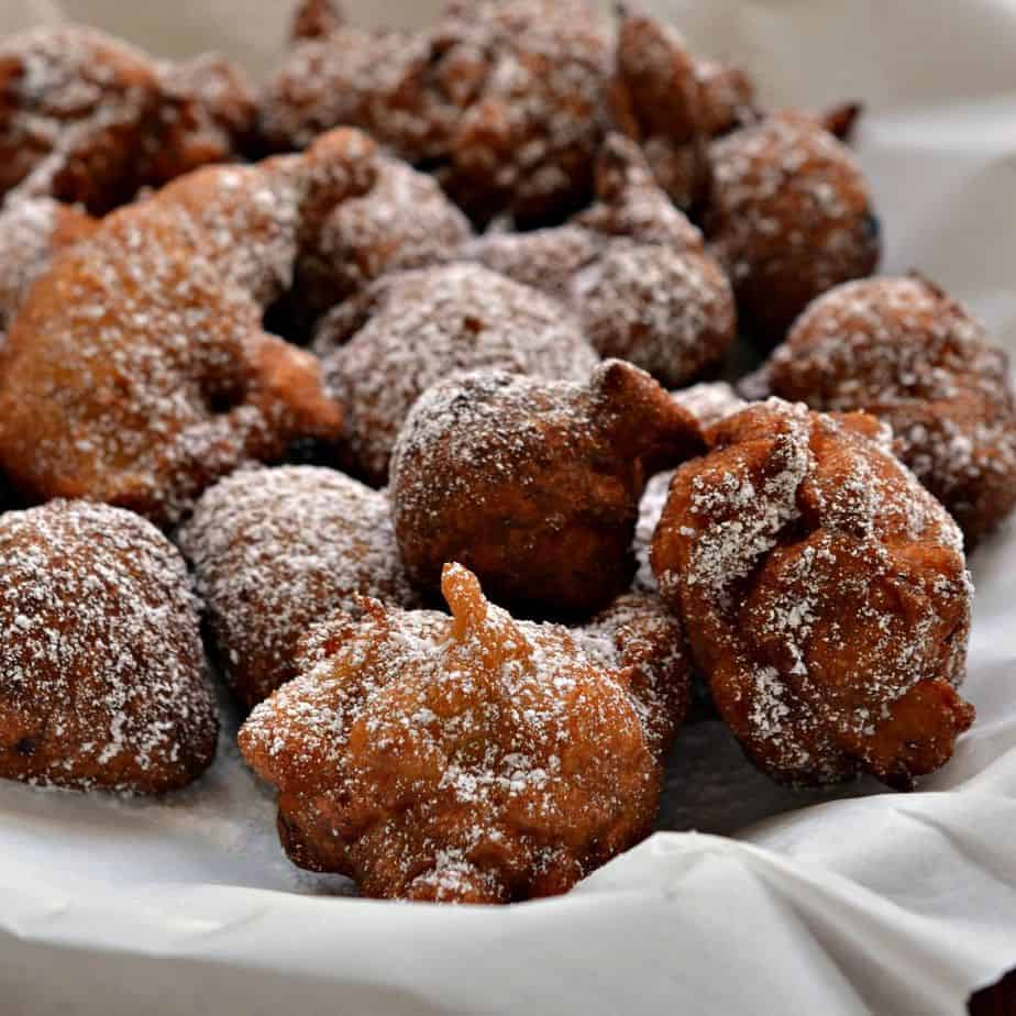Crispy fried banana fritters coated with a light dusting of powdered sugar