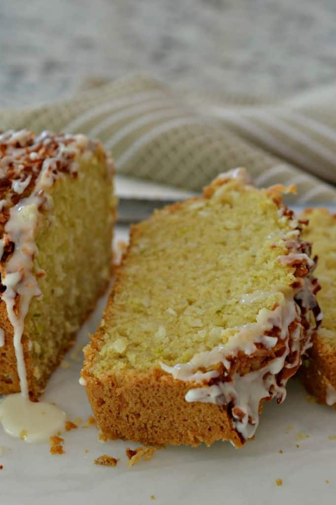 This Coconut Bread Recipe is topped with sweet toasted coconut and a citrus icing drizzle