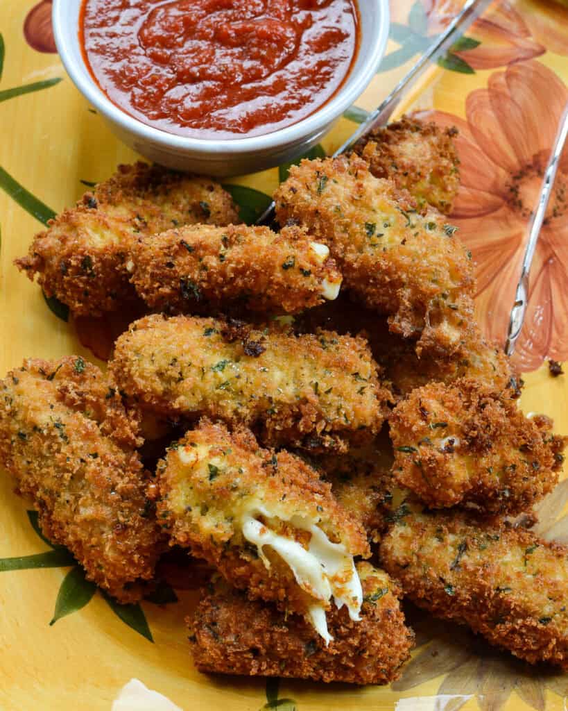 Overhead shot of mozzarella sticks on a platter.