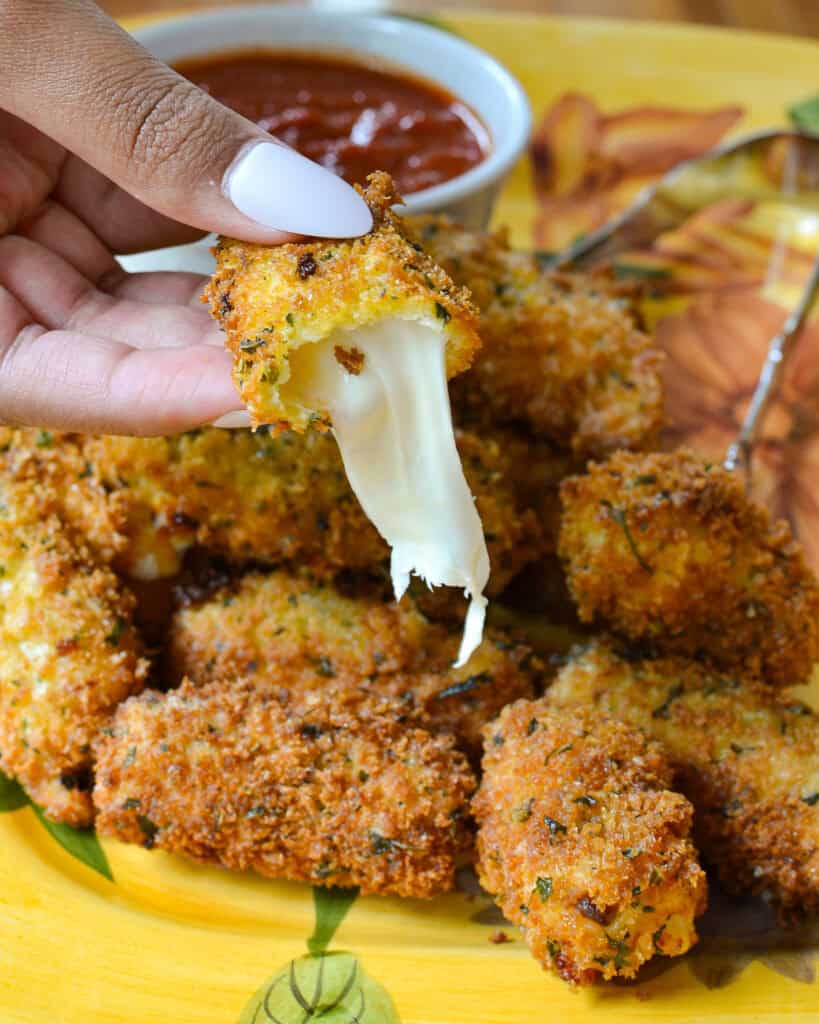 A close up of an open mozzarella stick.