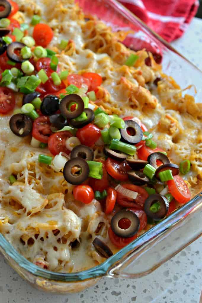 How to Make Frito Pie: A delicious taco casserole topped with your favorite taco toppings, and the salty crunch of Fritos