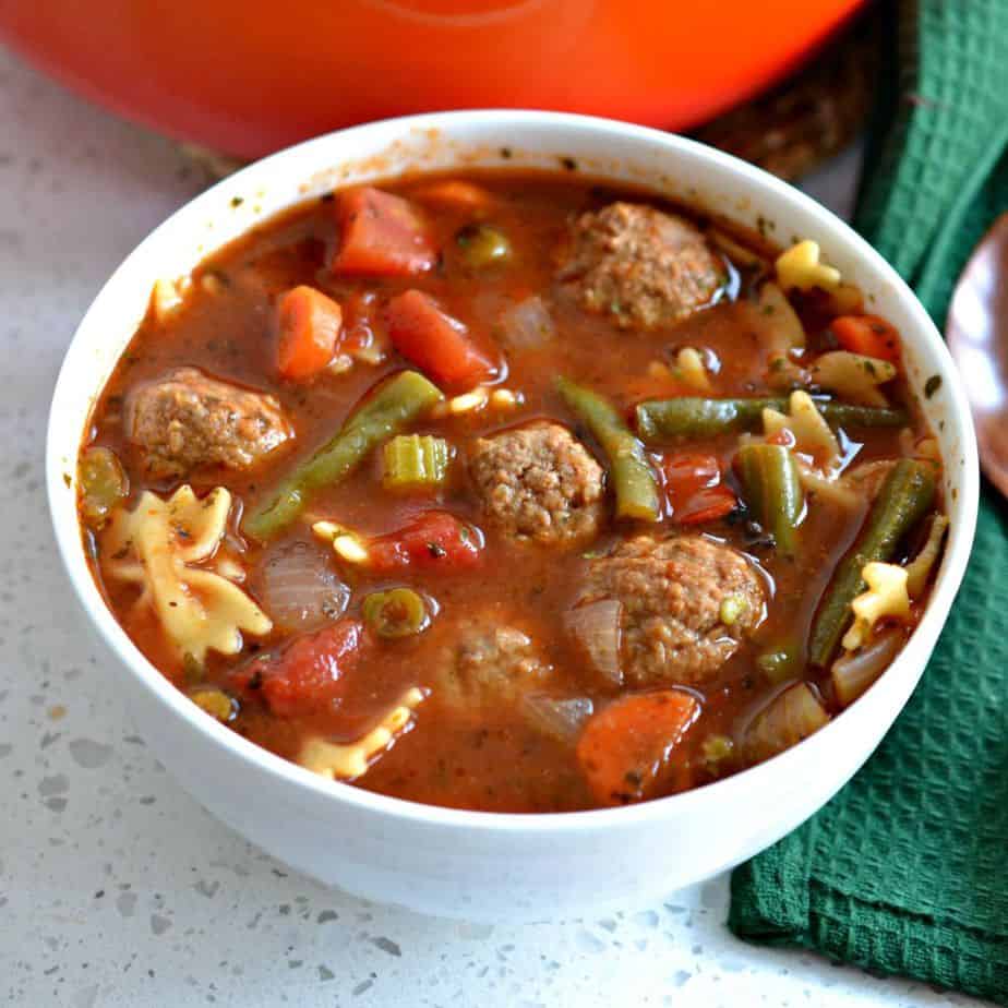 Soup with meatballs, carrots, celery, tomato and green beans. 