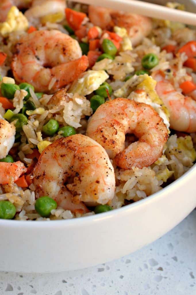 This delicious homemade fried rice recipe is made with whole shrimp, and peas, carrots, and eggs in perfectly cooked rice.
