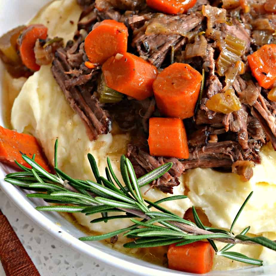 Tender Braised Beef is made easy in a Dutch oven with chuck roast, onions, celery, carrots, and fresh herbs in beef broth with a little bit of red wine. 