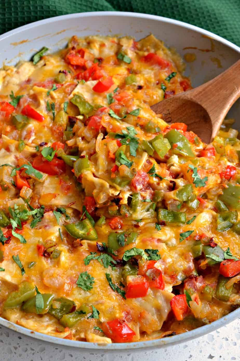 King Ranch Chicken is a fun family recipe full of layers of shredded chicken, corn tortillas, onions, bell peppers, garlic, jalapenos, and tomatoes in a creamy chicken sauce and topped with cheddar jack cheese. 