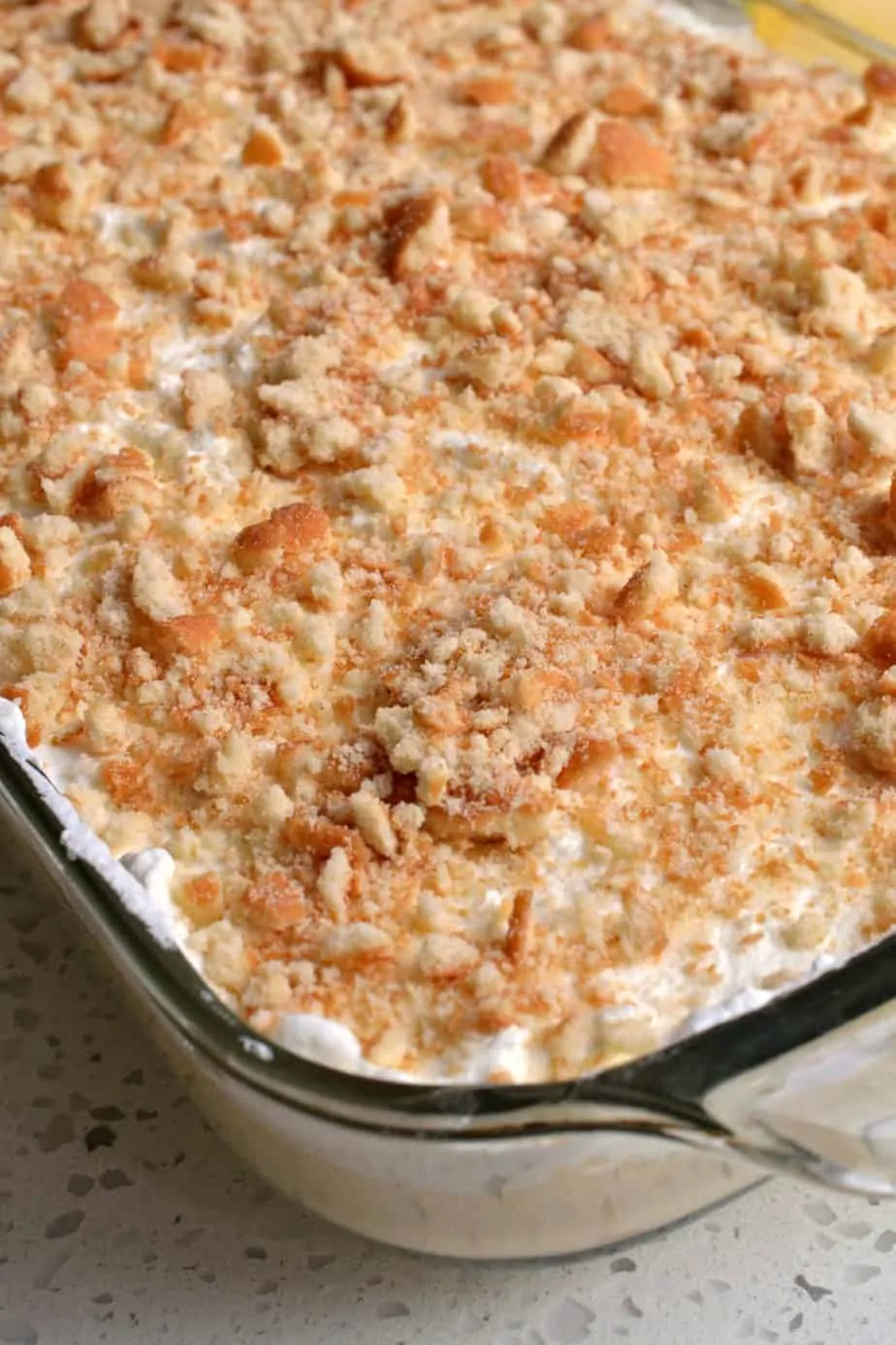 This completely from-scratch banana pudding is topped with fresh whipped cream and crumbled vanilla wafers